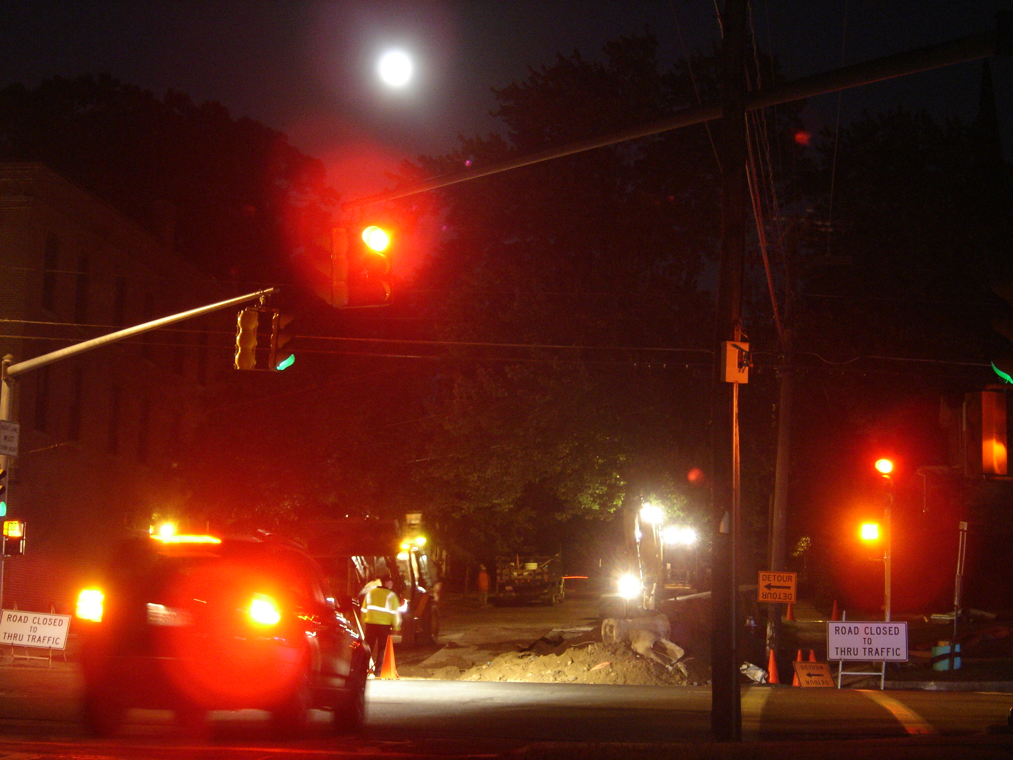Work crews at night digging a trench on 7th Street in Turners Falls, September 2006, with full moon overhead.